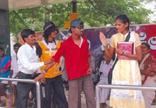 Youth forum members stopping eve teasing at a bus stop in Bellary, Karnataka